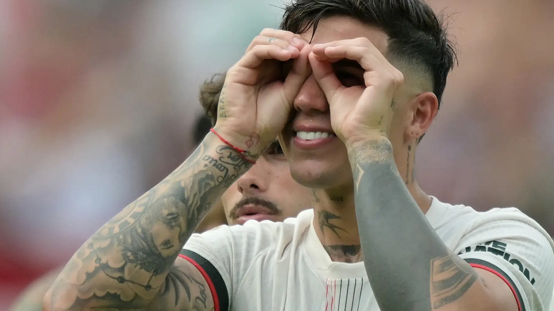 A person mimes looking through binoculars with their hands.